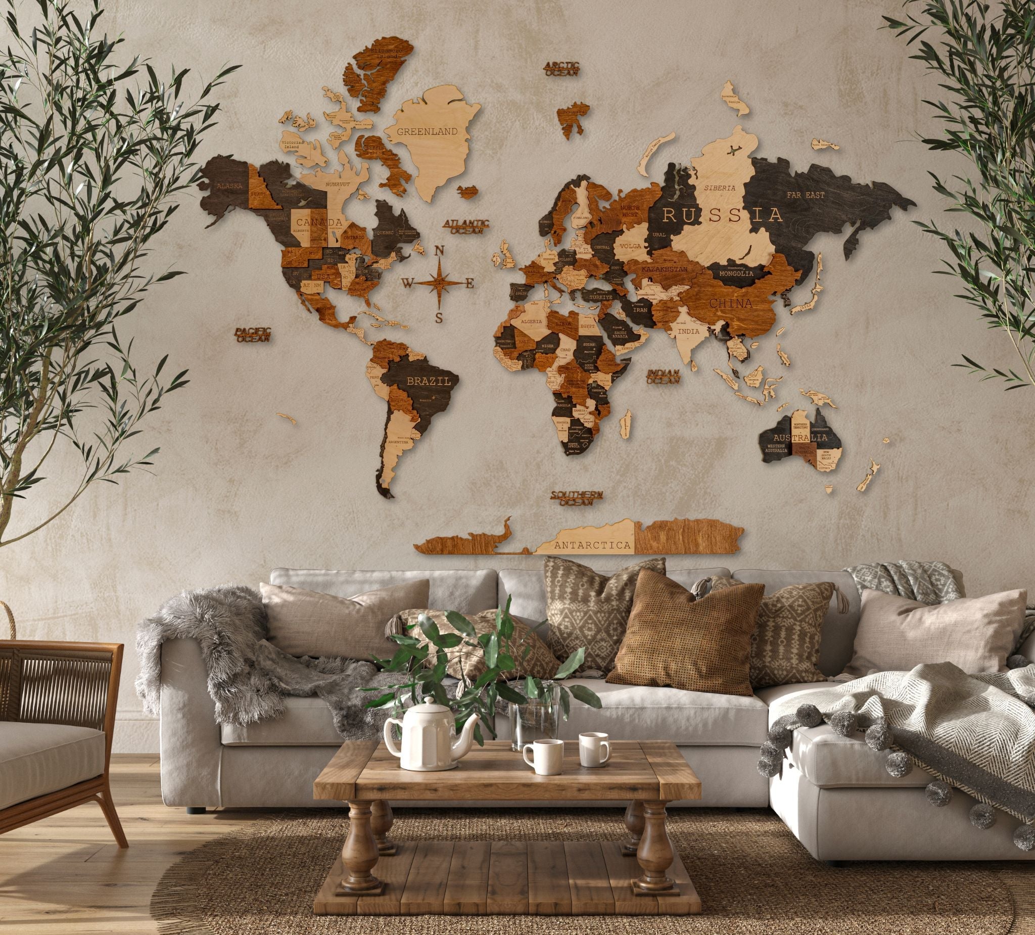 A 3D wooden map of the world with varying shades of brown, mounted on a wall above a sofa in a living room setting.