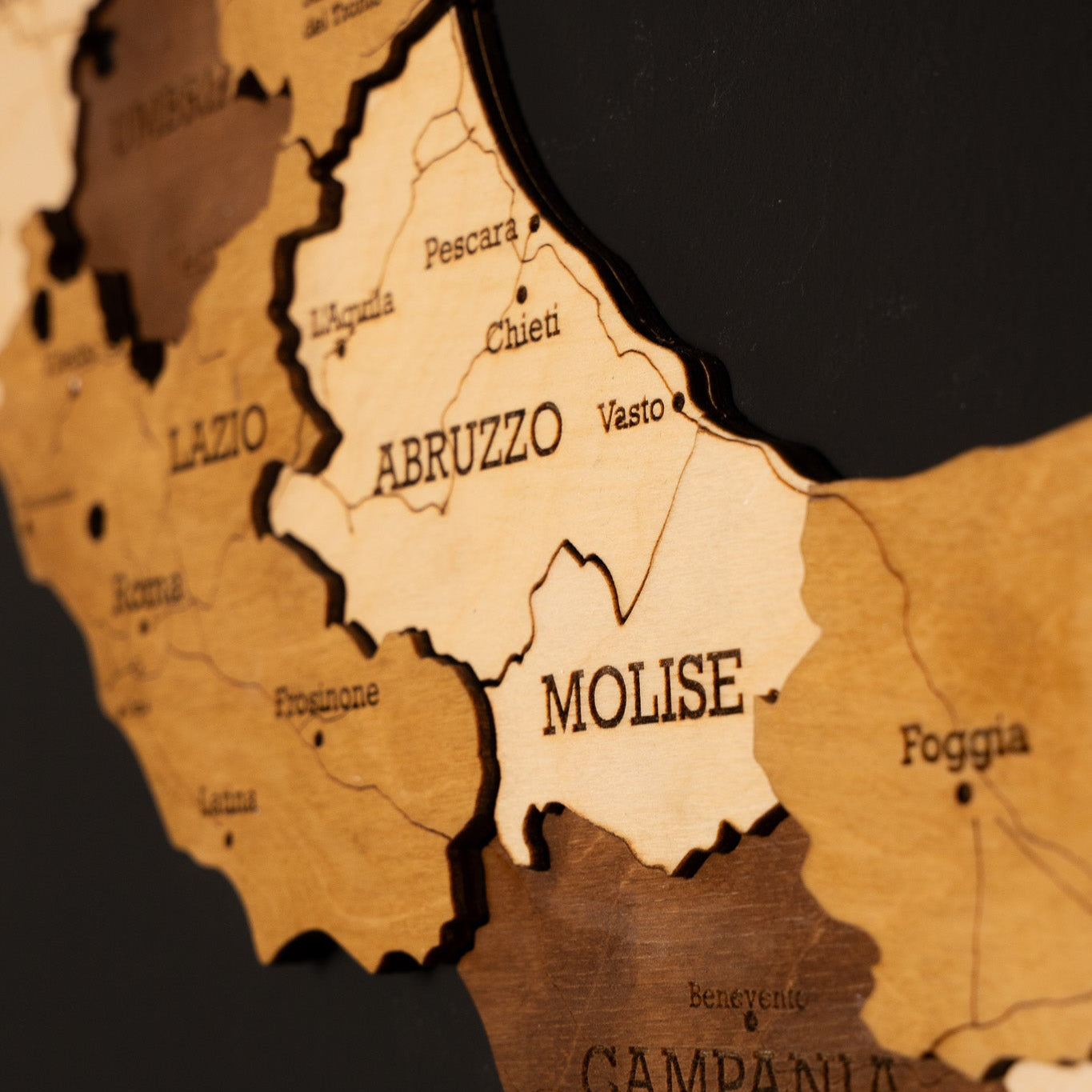 Detail of laser-cut Italy 3D map in obsidian black and beige