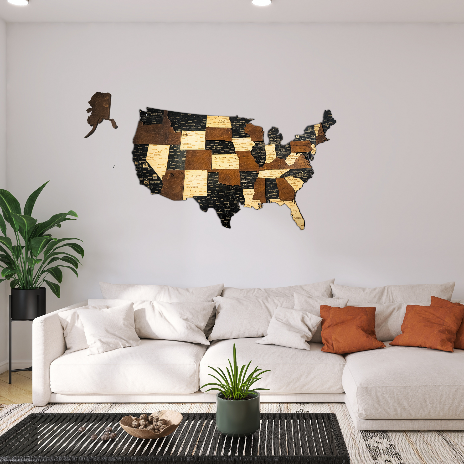 Wooden wall art of the United States in a living room setting with a white sofa and decorative plants.